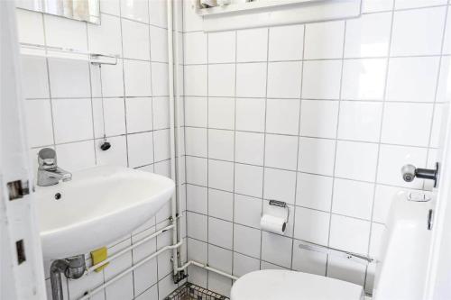 a white bathroom with a sink and a toilet at K19015-Kalundborg-Klintegardsvej-45 in Kalundborg
