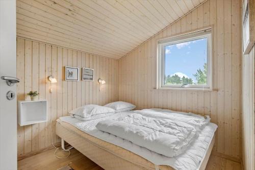 a bedroom with a bed in a room with a window at SL313-Slagelse-Rorhonevej-12 in Slagelse