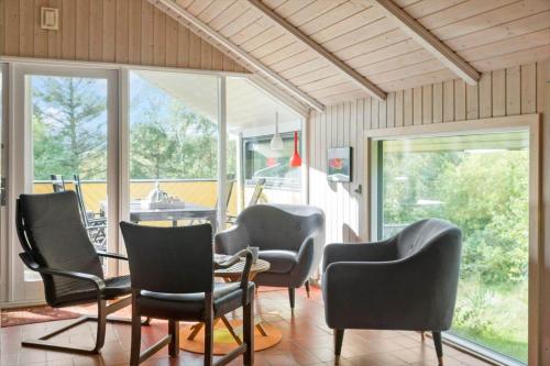 a room with chairs and a table and a porch at K19007-Kalundborg-Strandskraenten-11 in Kalundborg