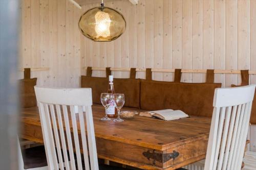 a wooden table with a bottle of wine and two glasses at K19007-Kalundborg-Strandskraenten-11 in Kalundborg