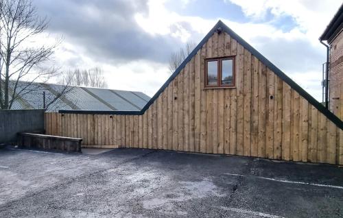 a wooden building with a window on the side of it at Stylish Lodge in the Peak District sleeps up to 9 in Upper Hulme