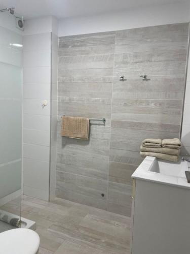 a bathroom with a shower with a toilet and a sink at Olimpus Apart Leasure in Costa de Adeje