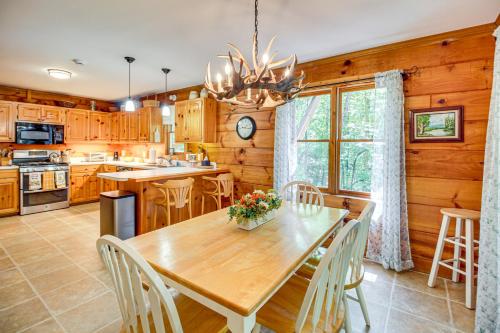 a kitchen with a wooden table and chairs and a dining room at North Georgia Cabin with Hot Tub and Community Perks! in Jasper
