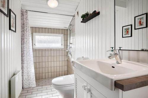 a white bathroom with a sink and a toilet at SL051-Slagelse-Dansvej-10 in Slagelse