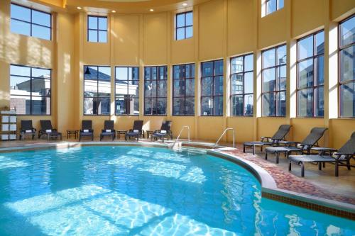 a large swimming pool in a building with windows at Marriott Bloomington Normal Hotel and Conference Center in Bloomington