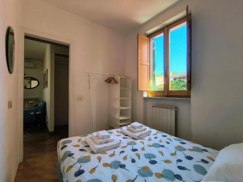 a bedroom with a bed with towels on it at Terrazza di Flamy - WelcomeToRhome in Rome