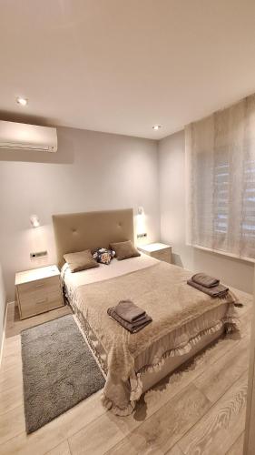 a bedroom with a large bed and a window at Casa fantástica en zona tranquila Un alojamiento para todos Nuestra casa es perfecta tanto para familias y amigos que buscan descanso, como para ciclistas que desean explorar la zona Para ciclistas ofrecemos un espacio seguro para guardar bicicle in Girona