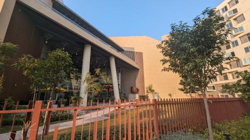 a building with a fence in front of it at Premium Guest House - Pentasquare in Lahore