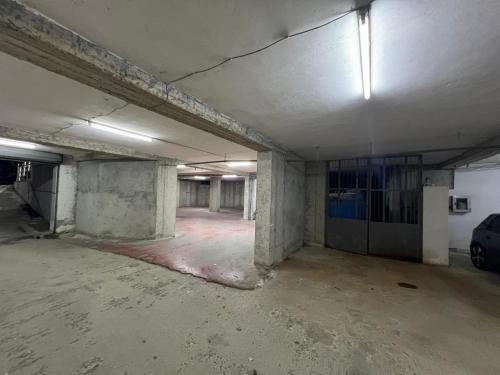 an empty room of a building with a car parked in it at Prime Luxury Apartments in Lushnjë