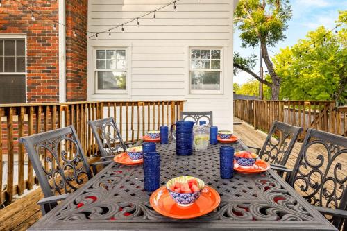 a table with plates of food on a patio at Walk to Schlitterbahn & Downtown Sleeps 12 in New Braunfels