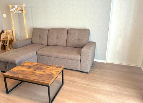 a living room with a couch and a coffee table at OKINAWA POOLWILLA ONNA 4A - Vacation STAY 48422v in Baba