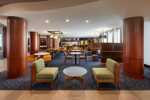 a lobby with tables and chairs and a restaurant at Courtyard Boston-South Boston in Boston