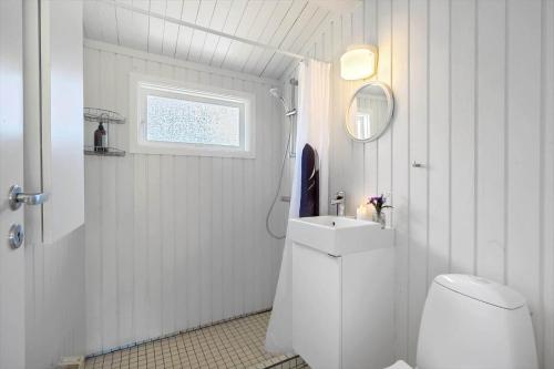 a white bathroom with a toilet and a sink at SL274-Korsor-Havstokken-16 in Korsør