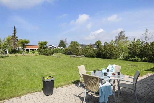 a patio with a table and chairs and a field at SL274-Korsor-Havstokken-16 in Korsør
