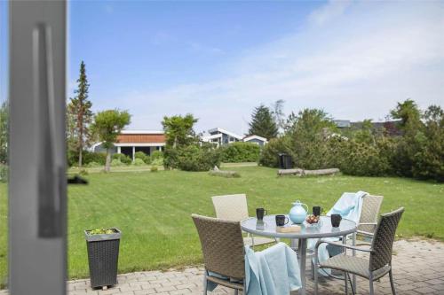 a table and chairs on a patio with a yard at SL274-Korsor-Havstokken-16 in Korsør