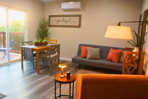 a living room with a couch and a table at Breathtaking Views Hilltop for Couples Firepit in Canyon Lake