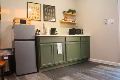 a kitchen with green cabinets and a refrigerator at Breathtaking Views Hilltop for Couples Firepit in Canyon Lake
