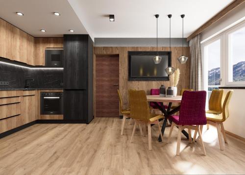 a kitchen and dining room with a table and chairs at Astellina hotel-apart in Ischgl