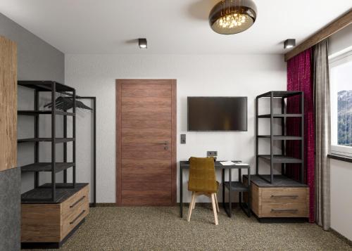 an office with a desk and a door and a chair at Astellina hotel-apart in Ischgl