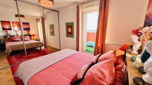 a bedroom with a bed and a large mirror at Chic apartment with panoramic view in Caen