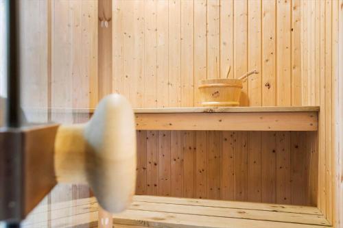 a wooden sauna with a bucket on a shelf at 20137-Samso-Topmejsevej-8 in Nordby
