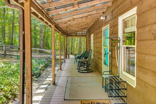 a covered porch of a house with chairs on it at Horses Welcome! Jamestown Home with Fenced Pasture in Jamestown
