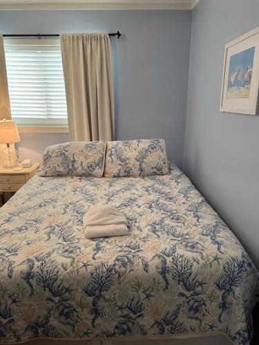 a bed with a white towel on it in a bedroom at Amenities and beach access! in Hilton Head Island