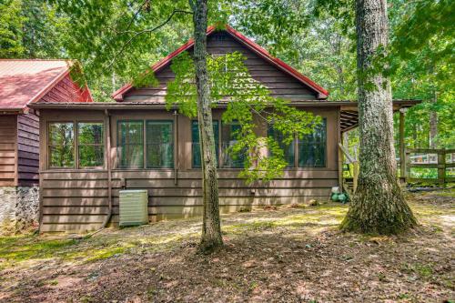 a log cabin with trees in front of it at Horses Welcome! Jamestown Home with Fenced Pasture in Jamestown