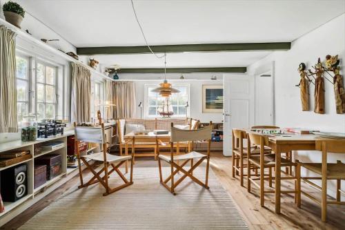 a kitchen and dining room with a table and chairs at 20509-Samso-Egevej-13 in Onsbjerg