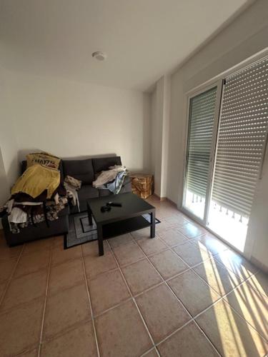 a living room with a couch and a coffee table at Piso alcaucin in Alcaucín
