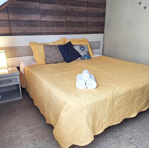 a bedroom with a bed with two towels on it at Porto Mar de Búzios in Búzios