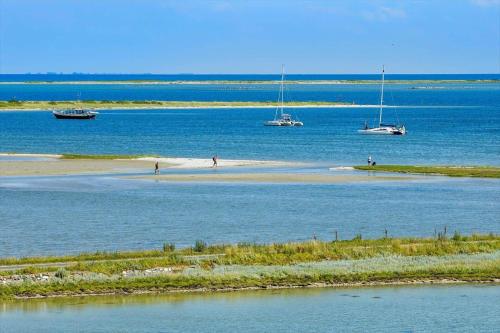 a beach with boats in the water and people on it at 20149-Samso-Landevejen-45 in Nordby