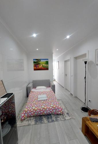 a bedroom with a bed in the middle of a room at Casa do Frade in Abrantes