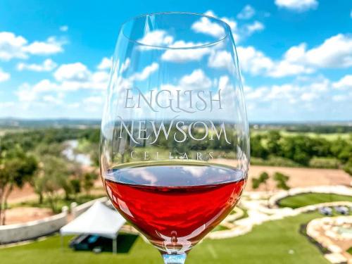 a glass of red wine sitting on a table at Resort at Fredericksburg Unit 4 in Rocky Hill
