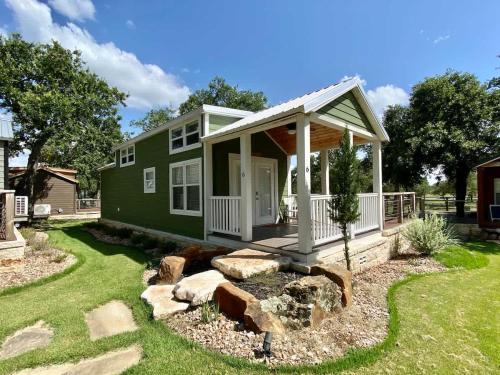 a green house with a porch and a yard at Resort at Fredericksburg Unit 4 in Rocky Hill