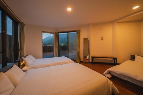 Ένα ή περισσότερα κρεβάτια σε δωμάτιο στο Yufudakeroten Nanafushi - Vacation STAY 62949v