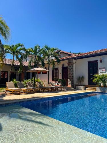 a villa with a swimming pool in front of a house at Casa Linaje Hotel Boutique by HMC -Cauca Viejo- Mayores de 10 años in Jericó