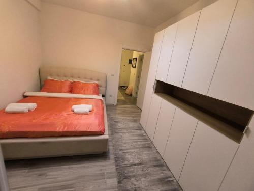 a bedroom with two beds with orange pillows on them at Apartment in Ferizaj in Ferizaj