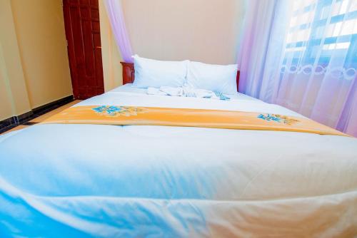 Postel nebo postele na pokoji v ubytování HBE HOTEL Kigamboni