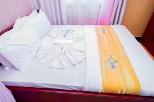 Postel nebo postele na pokoji v ubytování HBE HOTEL Kigamboni