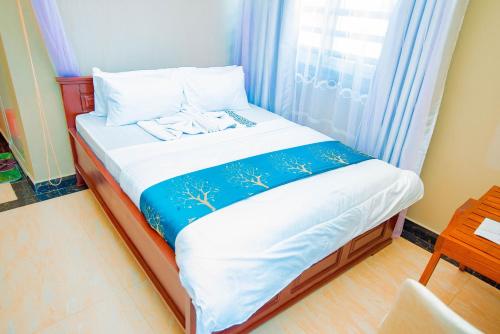 Postel nebo postele na pokoji v ubytování HBE HOTEL Kigamboni