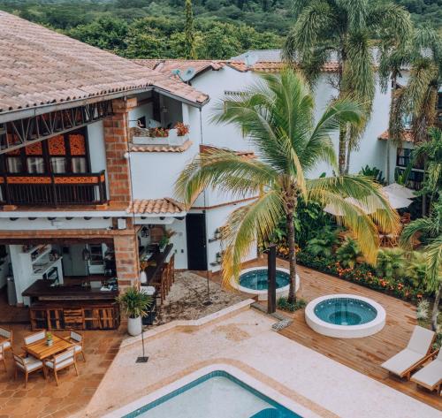 an aerial view of a house with a pool and palm trees at Casa Linaje Hotel Boutique by HMC -Cauca Viejo- Mayores de 10 años in Jericó