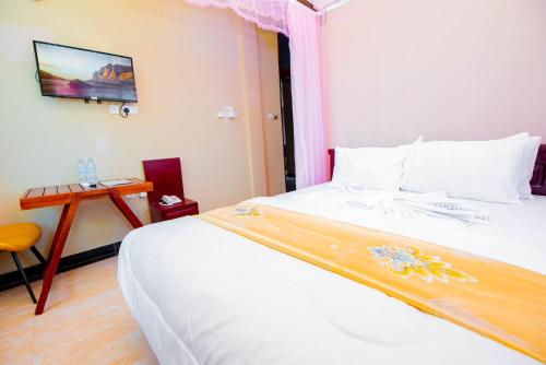 Postel nebo postele na pokoji v ubytování HBE HOTEL Kigamboni
