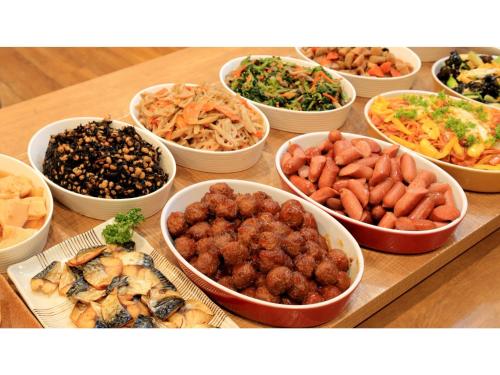 a table topped with bowls of different types of food at Smile Hotel Kawaguchi - Vacation STAY 05018v in Kawaguchi