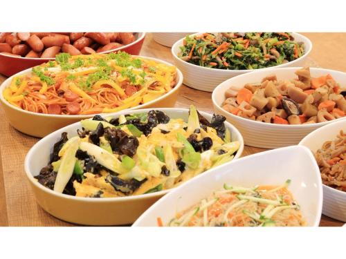 a table topped with bowls of different types of food at Smile Hotel Kawaguchi - Vacation STAY 05018v in Kawaguchi
