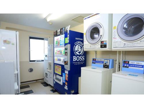 a room with a washing machine and a washer and dryer at Smile Hotel Kawaguchi - Vacation STAY 05018v in Kawaguchi