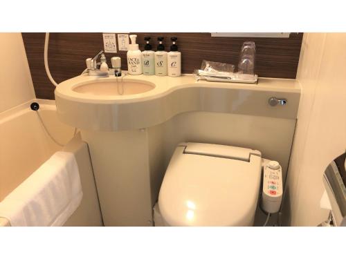 a small bathroom with a toilet and a sink at Smile Hotel Kawaguchi - Vacation STAY 05018v in Kawaguchi