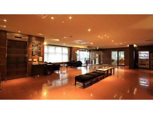 a lobby with couches and tables in a building at Smile Hotel Kawaguchi - Vacation STAY 05011v in Kawaguchi