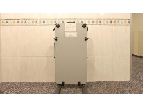 a metal refrigerator in front of a wall at Smile Hotel Kawaguchi - Vacation STAY 05011v in Kawaguchi