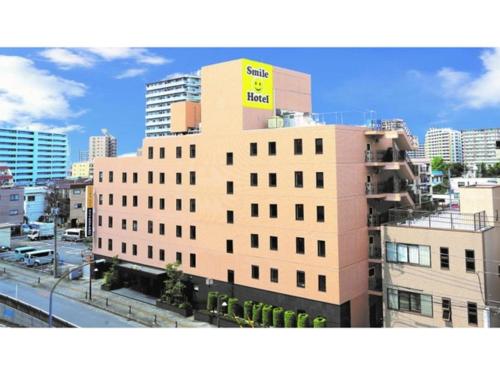 a building with a yellow sign on top of it at Smile Hotel Kawaguchi - Vacation STAY 05011v in Kawaguchi